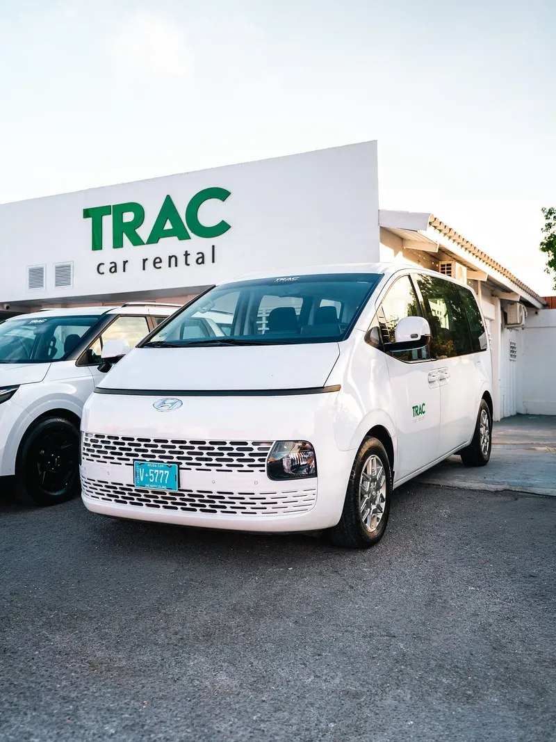 TRAC's white Hyundai Staria in front of the TRAC Car Rental office
