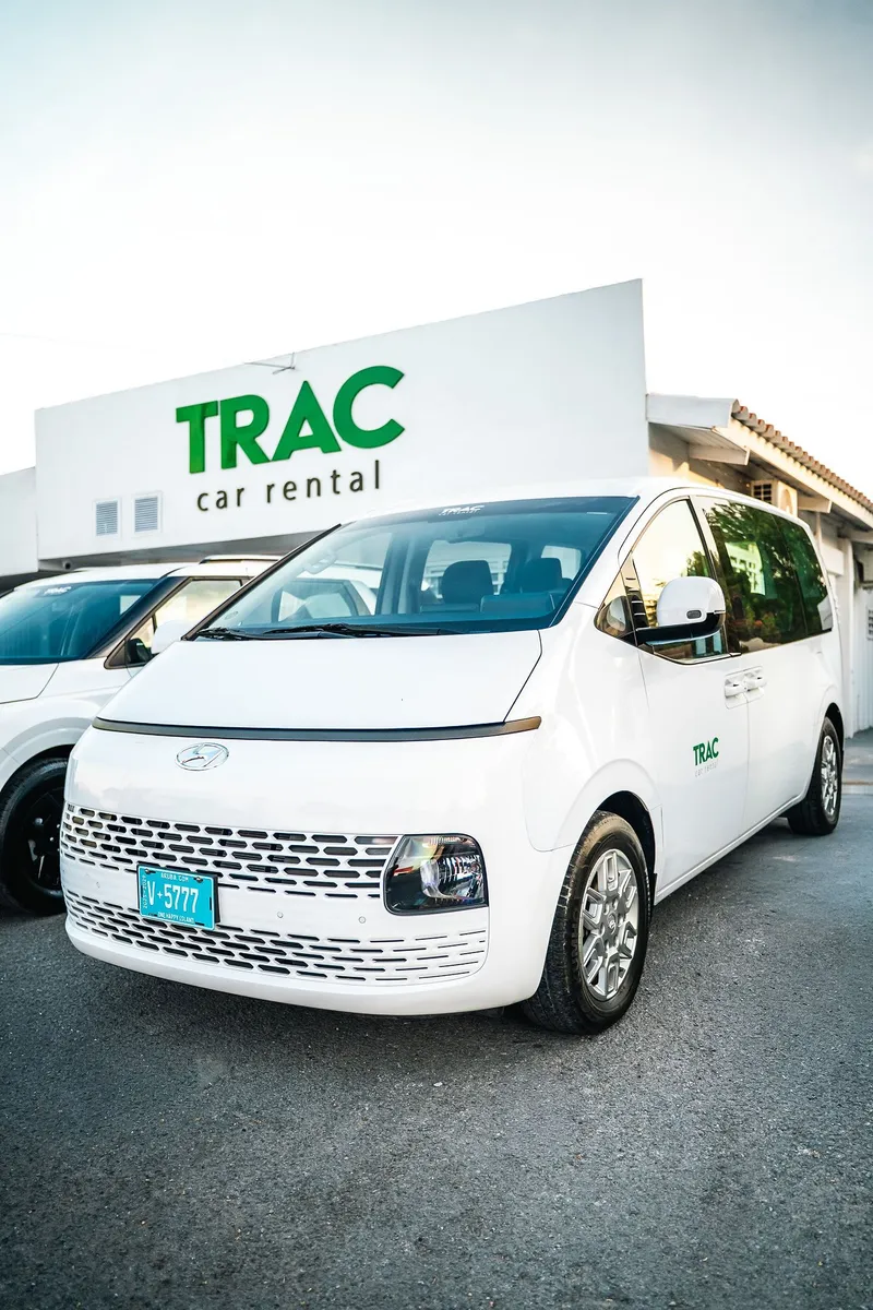 TRAC's white Hyundai Staria from the front and side, at the TRAC office